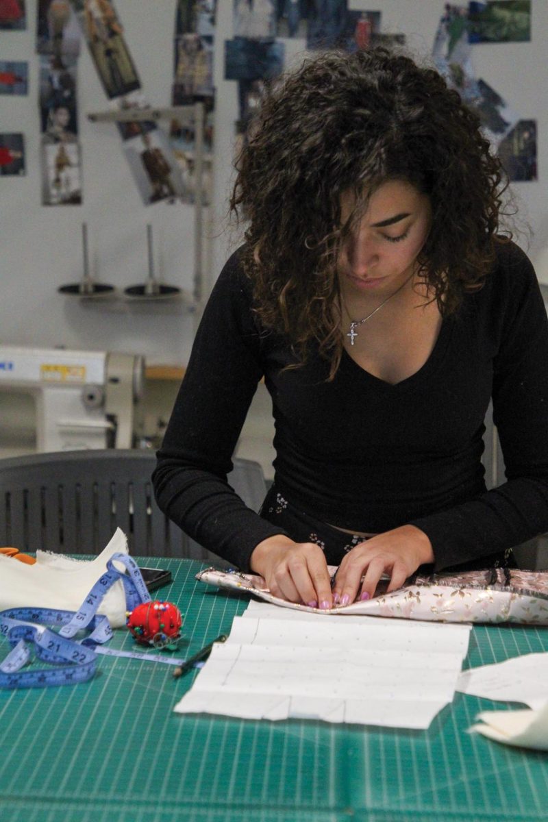 Christine Awad, an apparel production and design senior, working on a corset in Sequoia Hall.