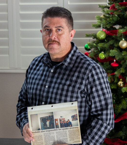 CSUN alumnus Aquiles Morales holds up the letter he wrote to The Daily Sundial in 1994, following the Northridge earthquake from that year, in Santa Clarita, Calif., on Dec. 2, 2023.