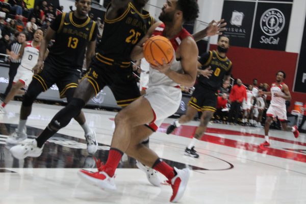Matadors forward DeSean Allen-Eikens drives to the rim to score a layup to give CSUN an early 5-0 lead while being defended by Long Beach forward Aboubacar Traore at the Premier America Credit Union Arena in Northridge, Calif., on Saturday, Feb. 17.