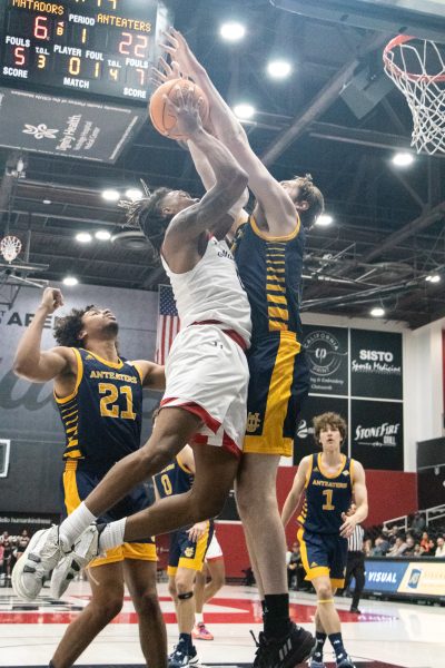 Guard Dionte Bostick, 0, goes up to the hoop against the UC Irvine defender on Thursday, Feb. 29, 2024, at the Premier America Credit Union Arena in Northridge, Calif.