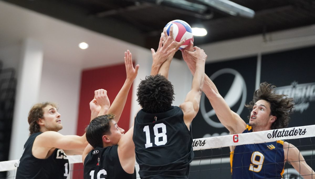 Outside Hitter Griffin Walters, 12, Middle Blocker Jano Tello, 16, and Opposite Jalen Phillips, 18, fight to push the ball over to the UC Irvine side at home in the Premier America Credit Union Arena in Northridge, Calif. on March 29, 2024.