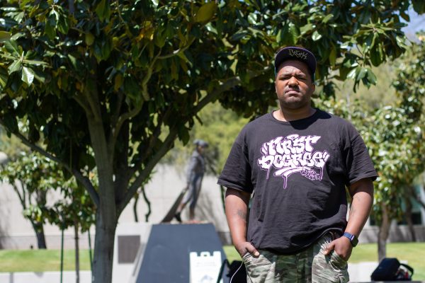David Adam Tucker stands on the lawn near Matador Square on Monday, April 29, 2024, wearing the shirt of one of his favorite bands First Degree. Your color and your disability don’t define you, says Tucker as he gives his wisdom and knowledge down to the Black autistic youth of today.