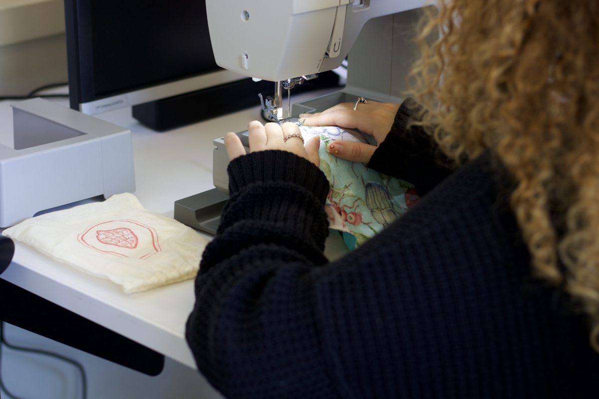 DIY+pad+workshop+attendee%2C+hosted+by+Go+With+the+Flow%2C+sewing+her+own+customized+pad+using+a+sowing+machine+on+Wednesday%2C+April+10+in+Sequoia+Hall.