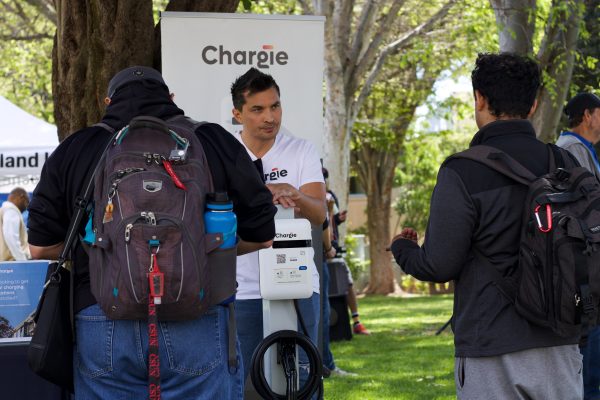 Students talking to Chargie representative during the 3rd annual EV car show on Wednesday, April 17 in Northridge, Calif.