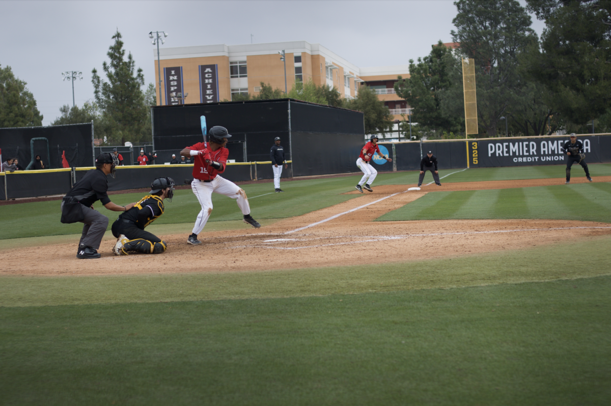 Infielder Kamau Neighbors, 19, batting as Andrew Gauna, 43, gets ready to come home from third base on Friday, April 12, 2024, against CSU Long Beach at the Matador Field in Northridge, Calif.