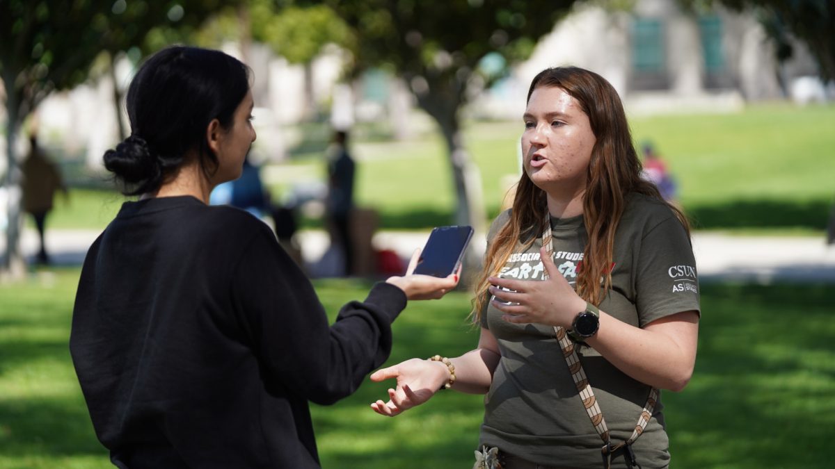 CSUN Student and event planner for the AS Sustainability Center, Nicole Burgess, answers questions regarding the Refill and Repair event at Matador Square in Northridge, Calif. on Tuesday, March 26, 2024.