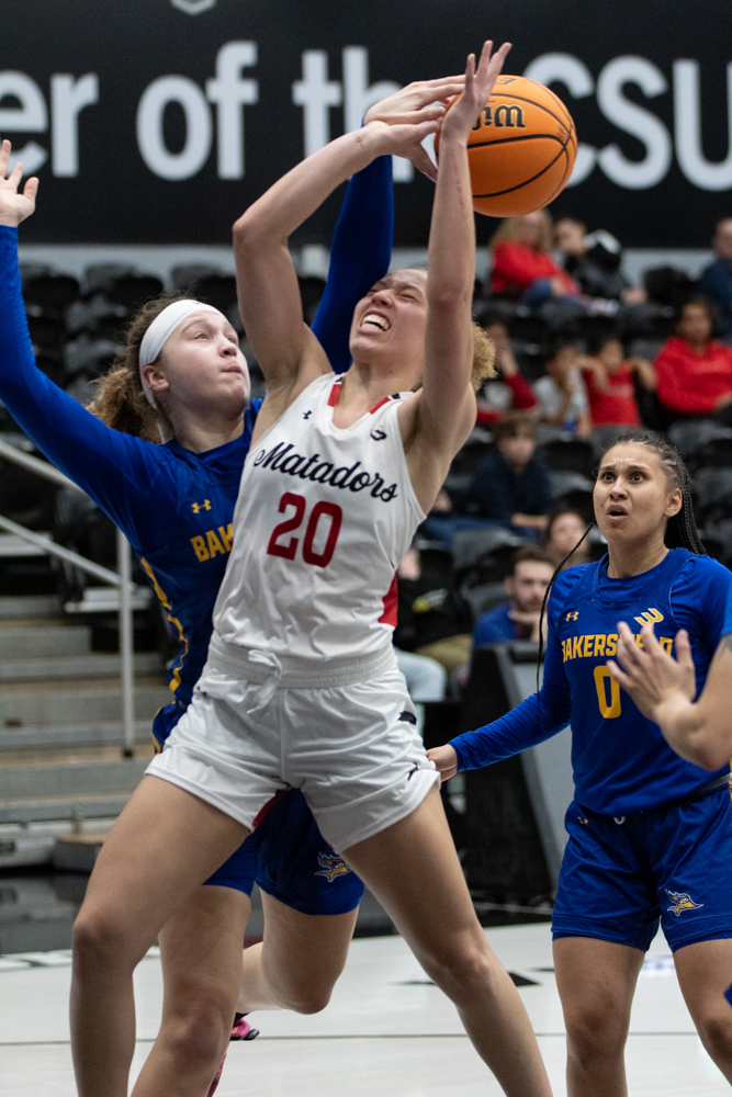 Guard Erica Adams, 20, takes the ball up to shoot and gets blocked by Cal State Bakersfield forward Julia Riley, 20, on Thursday, Feb. 15, 2024, at the Premier America Credit Union Arena in Northridge, Calif.