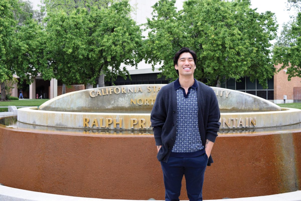 Post-doctoral counselor fellow Dr. Joshua Chow in front of the Ralph Prator Fountain.