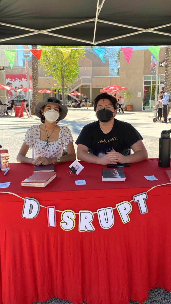 Alyssa Avila (left) and Luther Whyde (right) tabling for DISRUPT at a campus event. (Photo courtesy of DISRUPT)