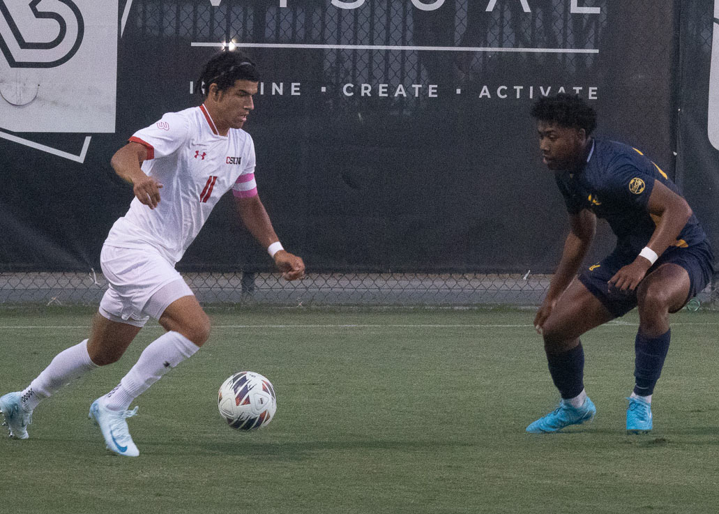 CSUN senior forward Marley Edwards, 11, tries to keep the ball rolling against University of California in their home match on Sunday, Sept. 1, 2024, in Northridge, Calif. 