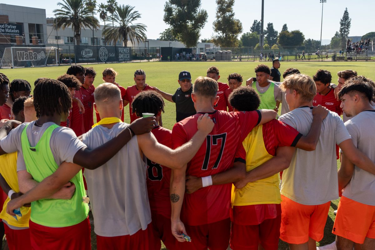 The CSUN men's soccer team huddles while Coach Terry Davila talks to them at Performance Soccer Field on Sunday, Sept. 22.