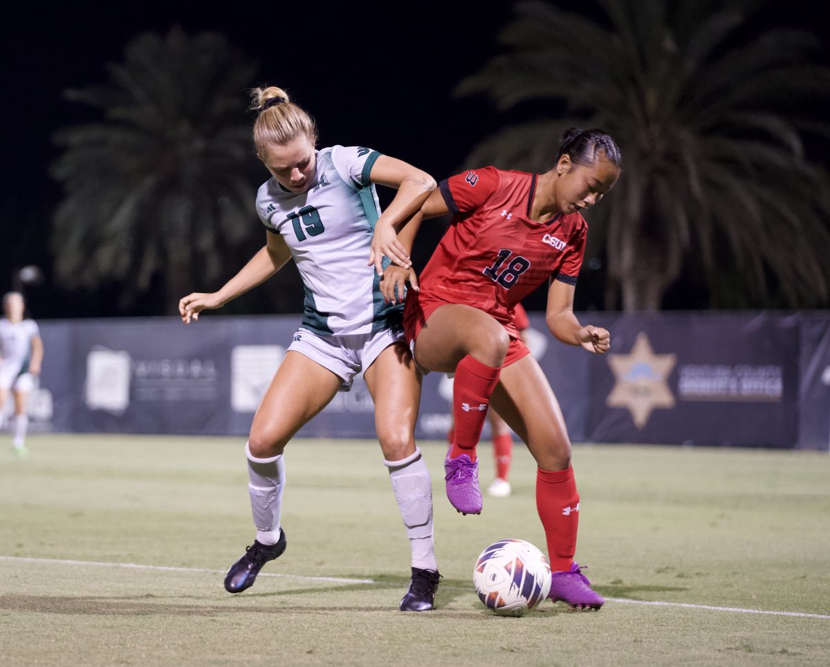 CSUN Women’s Soccer forward Cassidy Imperial-Pham, 18, protects the ball from Hawaii Women’s Soccer defender Zabiola Zamora,19, at the Matador Soccer Field on Oct. 3, 2024.