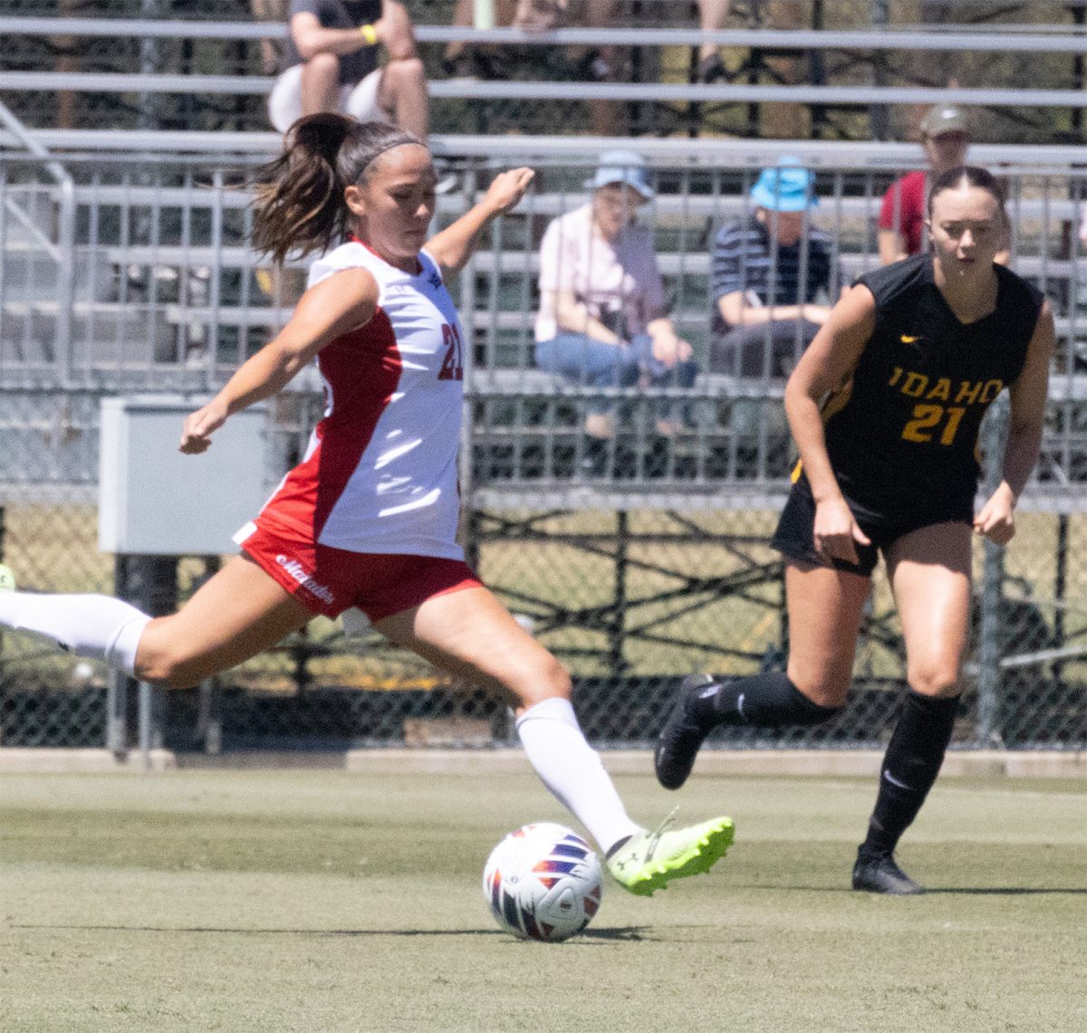 CSUN defensive midfielder Ashly Torres, 21, is about to strike the ball past the Idaho soccer player during the game on Thursday, Aug. 22 at the Performance Soccer Field.