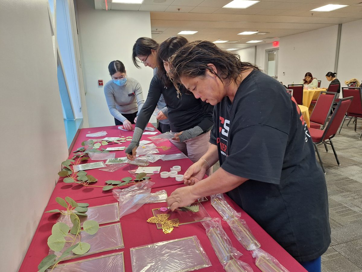 Students are led by DREAM Center Supervisor Karen Castillo through picking and choosing through the decorations offered for the picture frame workshop.