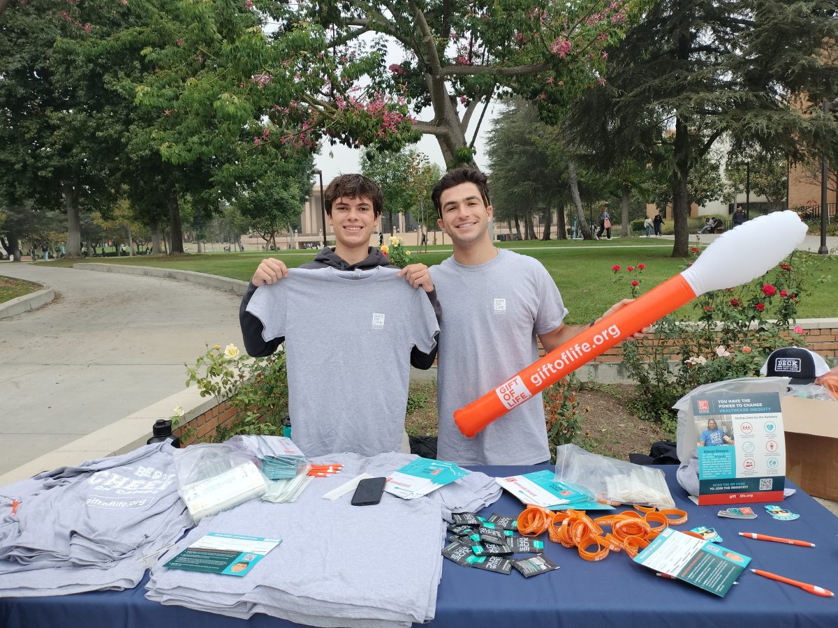 From left, Daniel Armin and Troy Horowitz, members of the Chi Nu chapter of Alpha Epsilon Pi at CSUN, posing at the Gift of Life table.