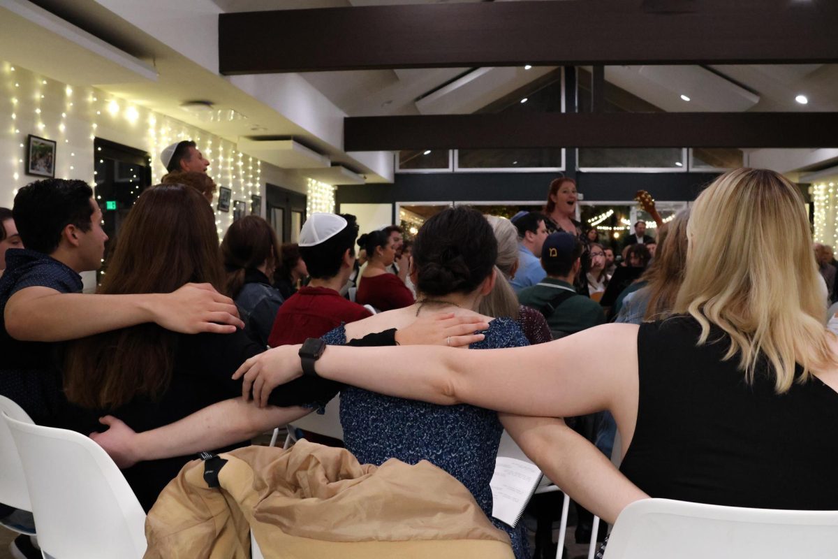 Students hold each other during Mega Shabbat prayer led by Rabbi Jess Yarkin.