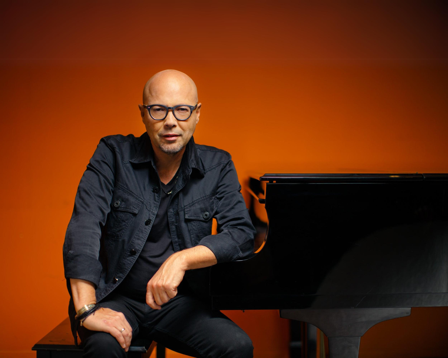 Jazz musician John Beasley, looking focused and sitting at a piano. (Photo courtesy of johnbeasleymusic.com)