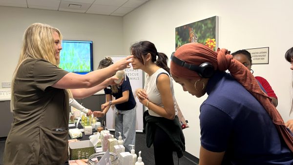 Representatives from Farmhouse Fresh showing CSUN students some samples of their body products. 