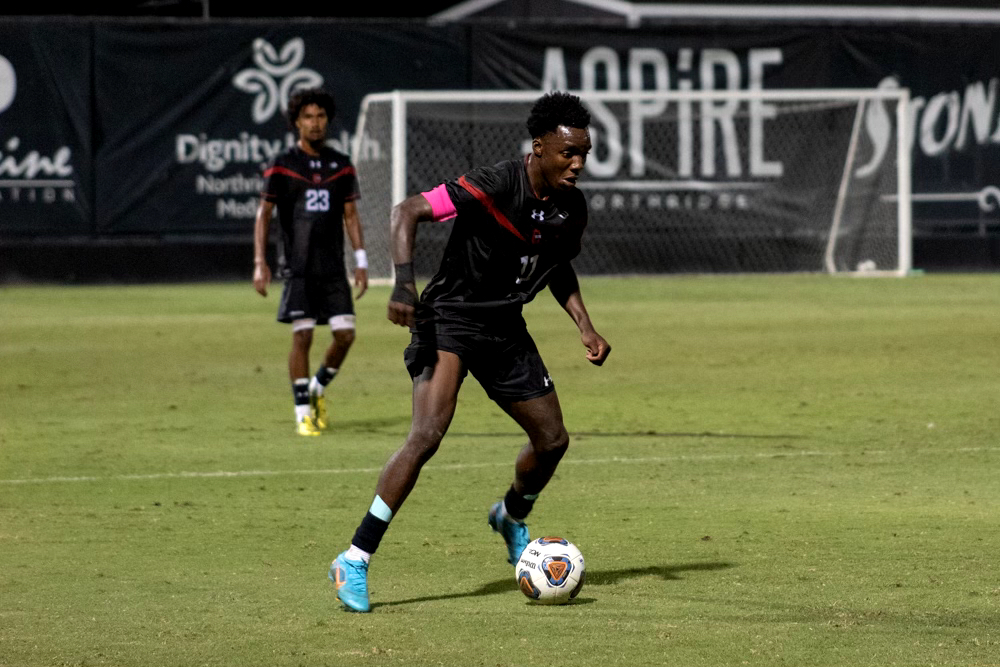 Forward Jamar Ricketts, 11, dribbles the ball down the field against UC Davis on Saturday, Oct. 8, 2022, at the Matador Soccer Field in Northridge, Calif.