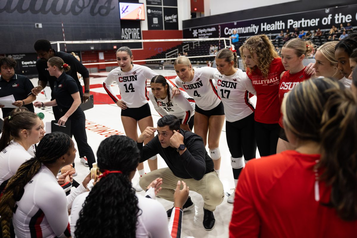 Head coach Aquiles Montoya speaks with the CSUN women's volleyball team during a timeout during the game against UC San Diego at the Premier America Credit Union Arena in Northridge, Calif. on Saturday, October 12, 2024.