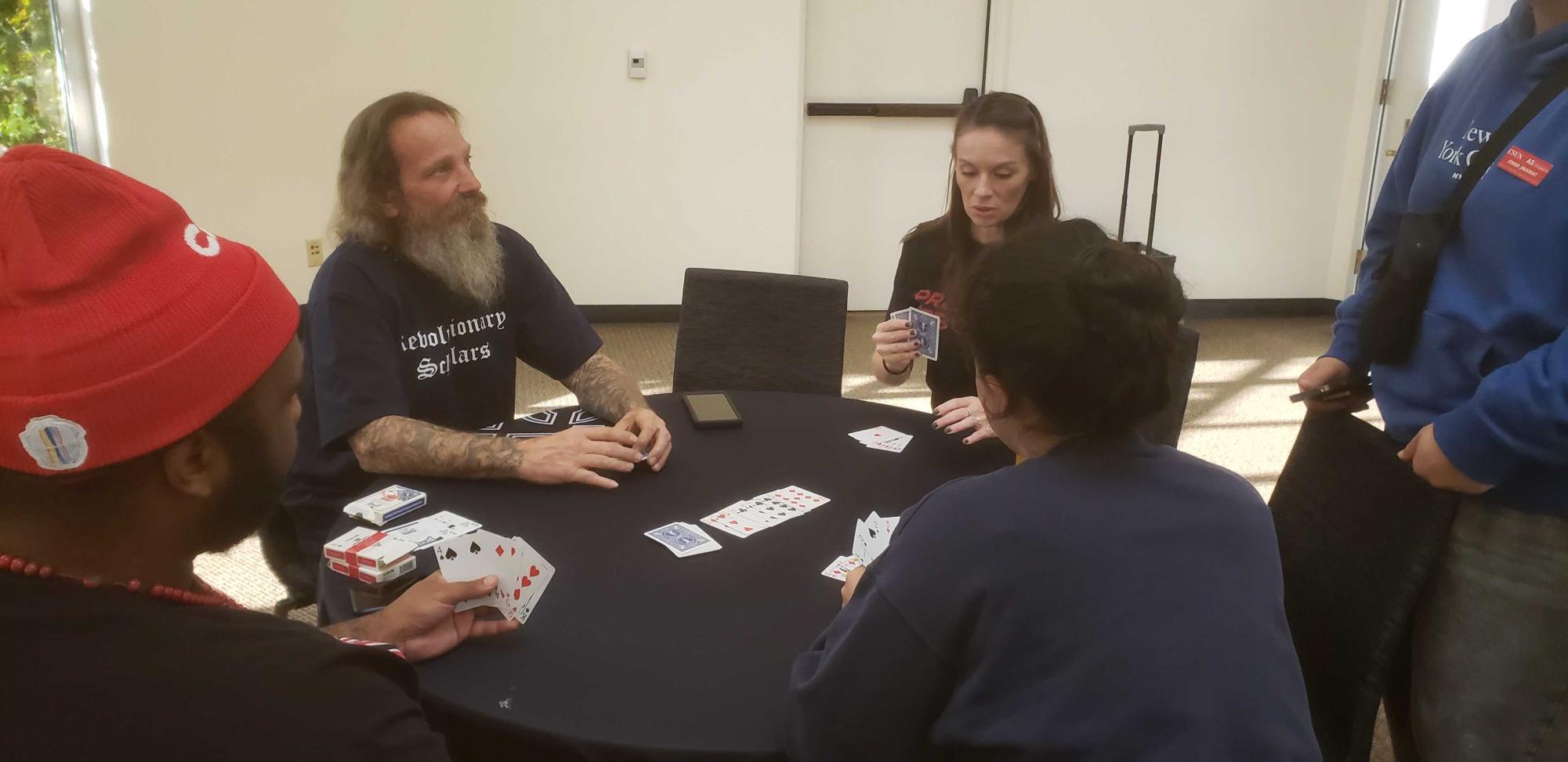 President Garret Eiferman and Vice President Ashley Fisher of Revolutionary Scholars playing a card game with students.