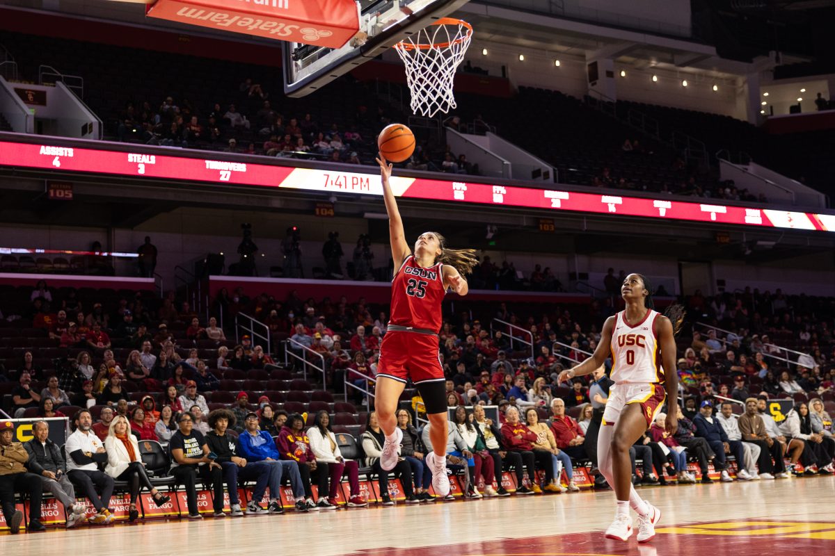 CSUN's guard Erika Aspajo, 25, goes up for a layup against USC's forward Vivian Iwuchukwu, 0, on Tuesday, Nov. 12, 2024, at the Galen Center in Los Angeles, Calif.