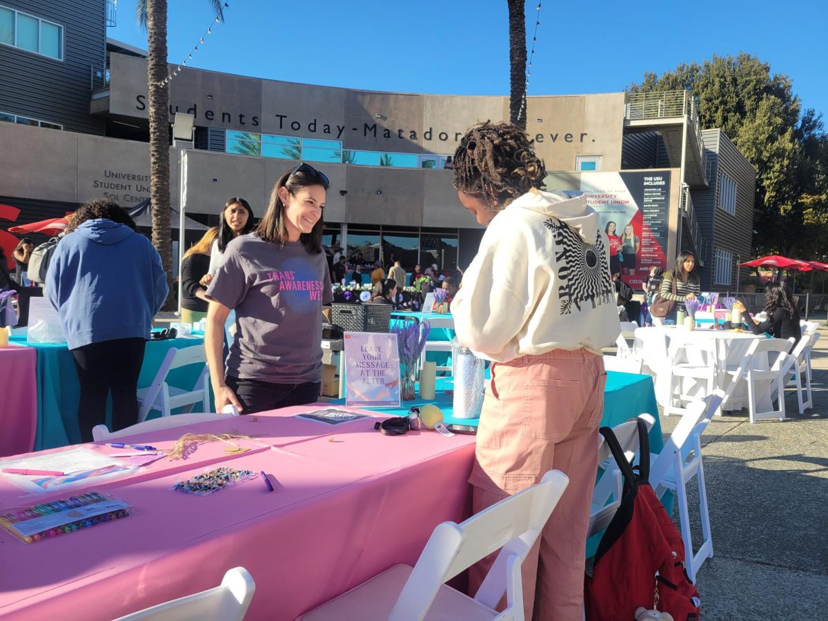 CSUN Therapist Amy Rosenblatt helping student at Trans Day of Remembrance event outside the USU on Nov. 20,2024.