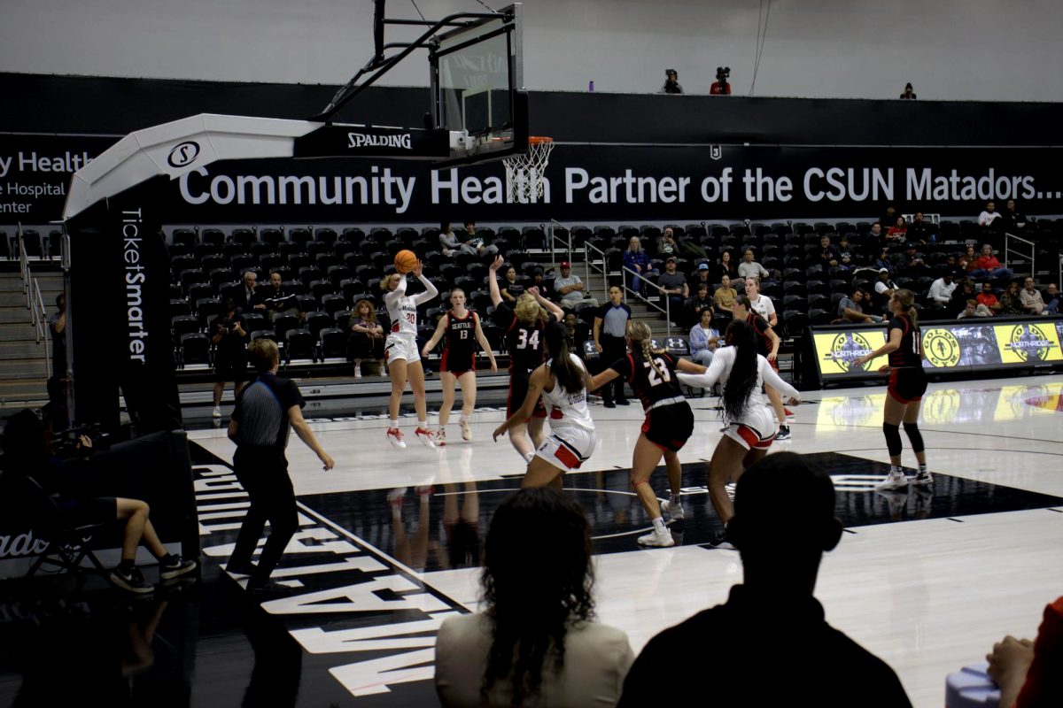 File Photo: Erica Adams, 20, takes a jump shot against the Redhawks’ defense Nov. 9 in Northridge, Calif.