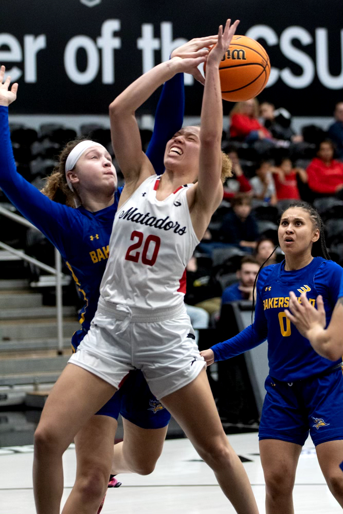 File Photo: Guard Erica Adams, 20, takes the ball up to shoot and gets blocked by Cal State Bakersfield forward Julia Riley, 20, on Thursday, Feb. 15, 2024, at the Premier America Credit Union Arena in Northridge, Calif.