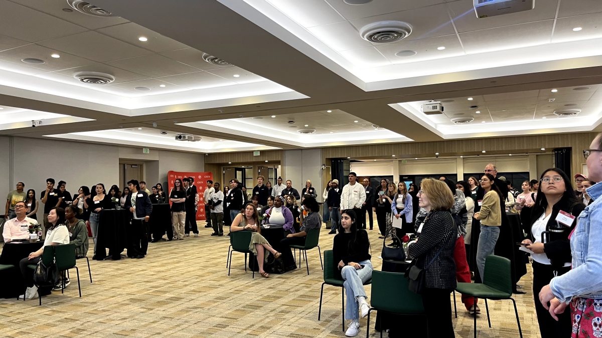 Attendees of the mixer listening to the clubs introduce themselves. 