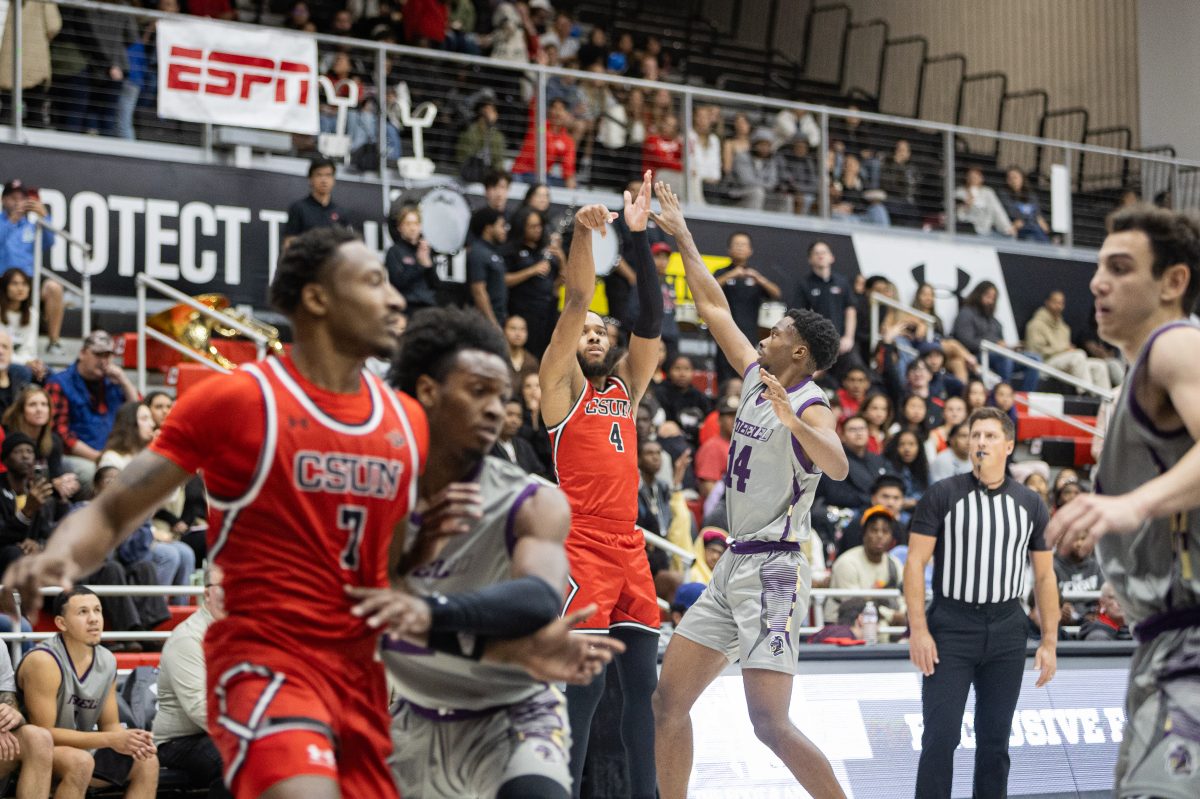 Matador guard, PJ Fuller II (center), 4, shoots the basketball over Nobel Knights Immanuel Lewis, 14, at the Premier America Credit Union Arena in Northridge, Calif., on Wednesday, Nov. 13, 2024.