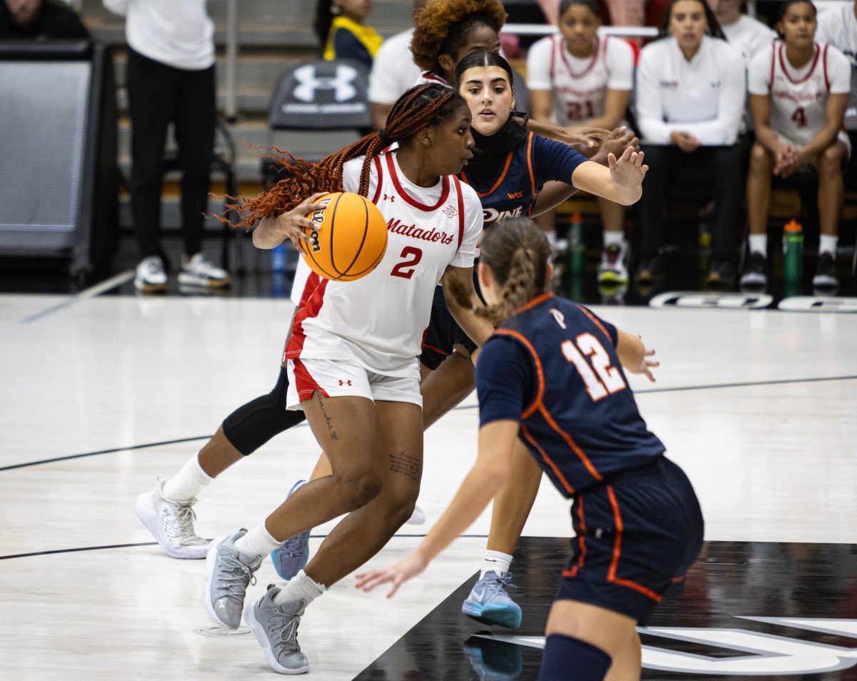 Matador guard Kayla Hopson, 2, drives into the basket as the Matadors lose to the Pepperdine Waves at the Premier America Credit Union Arena in Northridge, Calif., on Nov. 27, 2024.