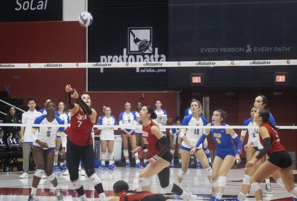 The Women's Volleyball team react to Amaris Smith, 7, setting up her team for a set point in the Premier America Credit Union Arena in Northridge, Calif., on Saturday, November 16th.