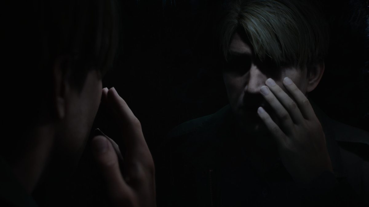 Silent Hill 2 Protagonist, James Sunderland, looking at himself in a mirror, existentially pondering his arrival at Silent Hill. Captured on PS5.