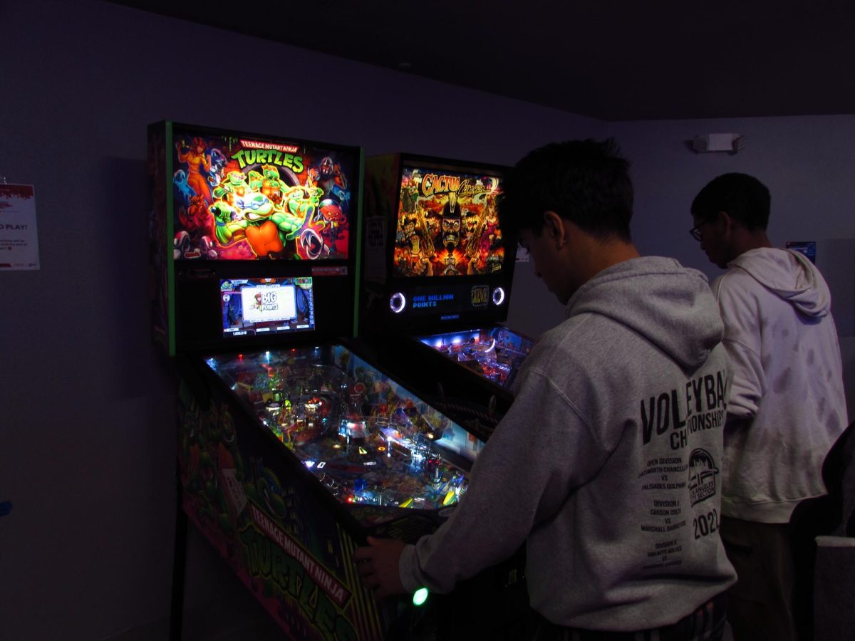 CSUN students attempting to set high scores on the new pinball machines in the USU Games Room on November 26, 2024.