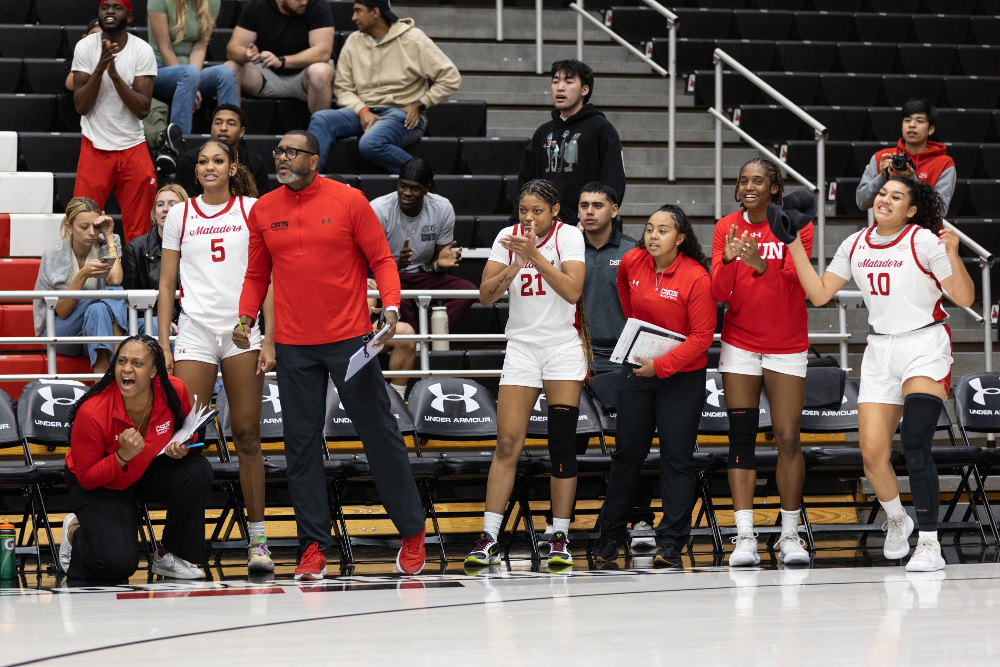 The CSUN bench celebrates after scoring against Cal Poly on Saturday, Dec. 7, 2024, in the Premier America Credit Union Arena in Northridge, Calif.