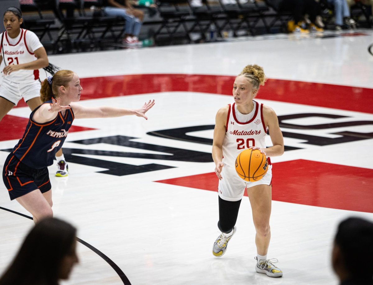 Matador guard Erica Adams, 20, dribbles towards the home bench as the Matadors fall to the Pepperdine Waves at the Premier America Credit Union Arena in Northridge, Calif., on Nov. 27, 2024.