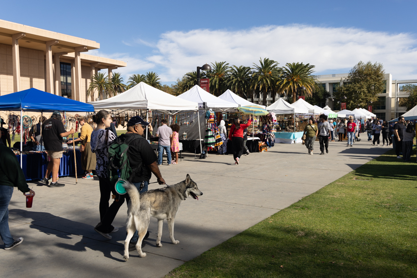 People attending the booths and watching the performances at the CSUN Powwow on Saturday, Nov. 30, 2024, in front of the University Library on campus.