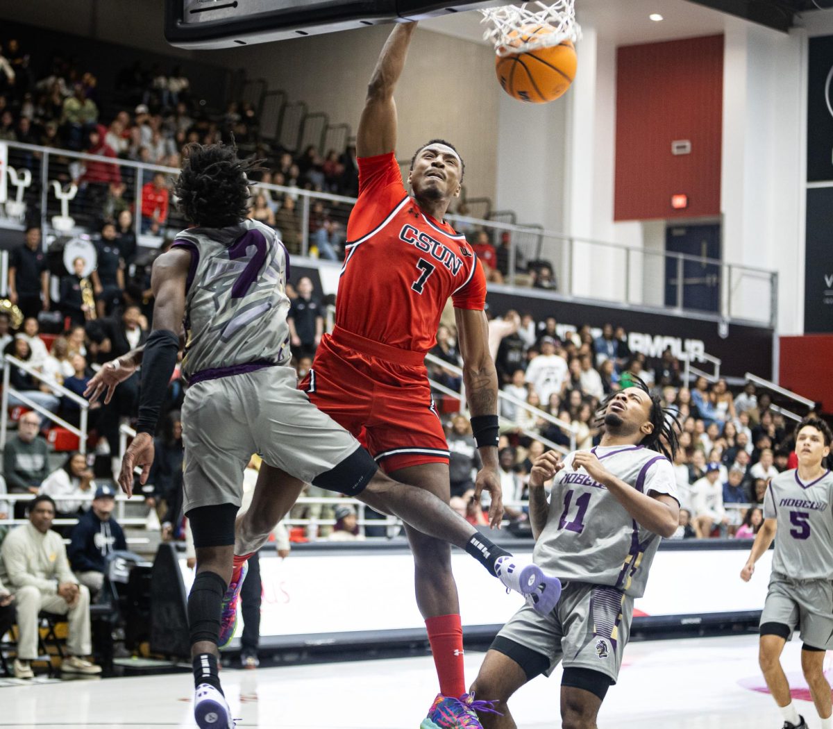 Matador forward Keonte Jones, 7, slams the ball over a Nobel Knight defender which electrified the crowd at the Premier America Credit Union Arena in Northridge, Calif., on Wednesday, Nov. 13, 2024.