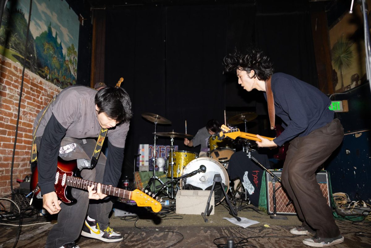 Brennan Shin and Grant Spitzer play guitars and jump to each beat as they perform "FiENDS" while Jonah Cho plays the drums during their set at The Smell in Los Angeles, Calif., on Thursday, Dec.  12, 2024. When asked about advice to students starting bands or pursuing music: “Don't quit," Spitzer said. "Keep going. And don't worry about the kind of labels and branding that people can try to put on you to make it so that they can understand what you're doing. Nobody understands what you're doing better than you, so trust yourself. Trust your artistic instinct. And just be as authentic as you can be and you'll reach the people who like you for you.”