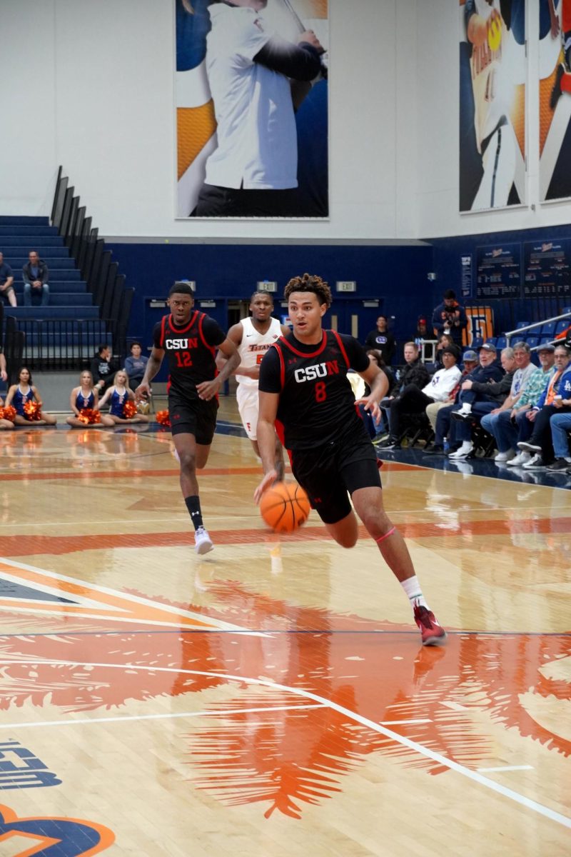 CSUN forward Marcus Adams Jr. (8) going up for a dunk vs. Cal State Fullerton on Jan. 2, 2025.