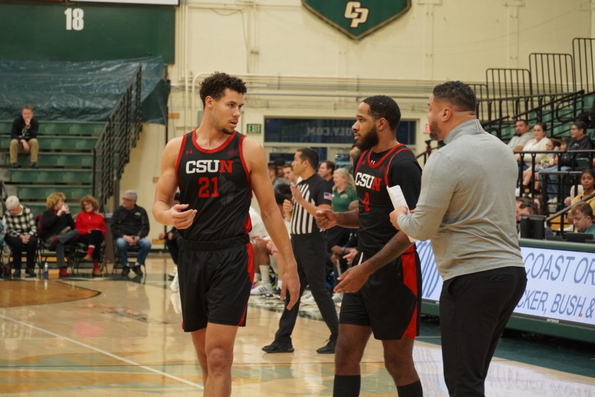 CSUN Forward Grady Lewis (21) and guard PJ Fuller (4) talking about their assignments vs. Cal Poly on Dec 7, 2024.