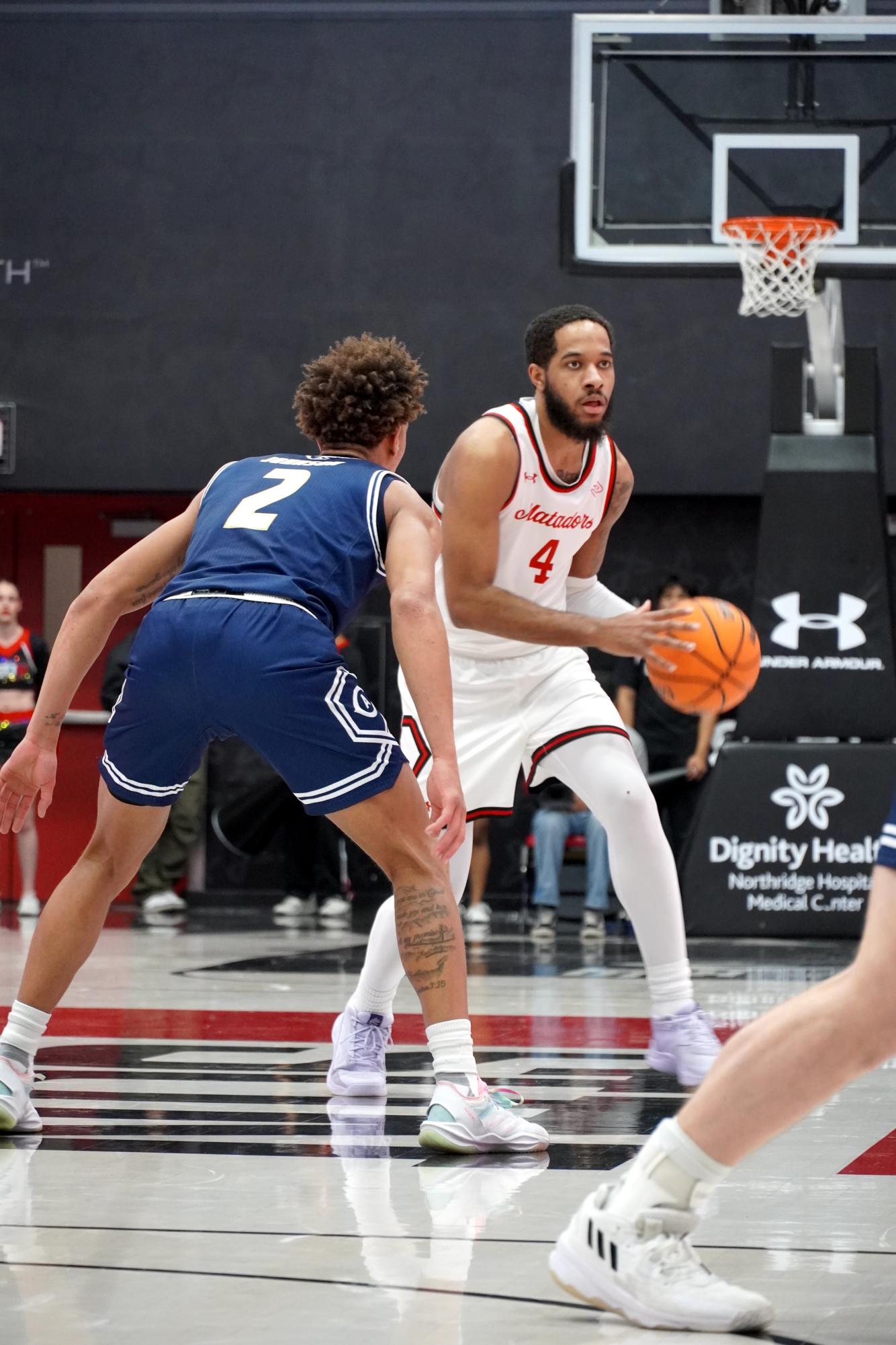 CSUN guard PJ Fuller (4) looking to make a pass vs. UC Davis on Jan. 4, 2025.