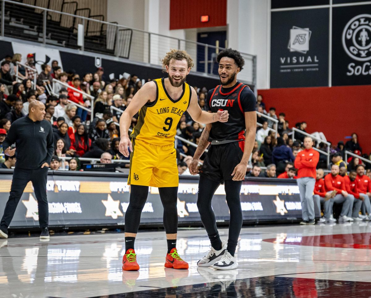 Matador guard Tyler Beard, 0, and Long Beach guard Devin Askew, 9, share a laugh on the court at the Premier America Credit Union Arena in Northridge, Calif., on Jan. 23, 2025.