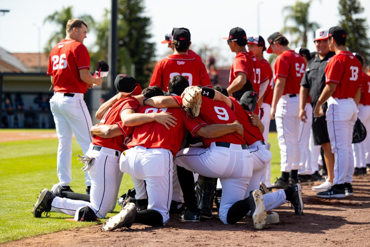 A group of players huddle together before the national anthem to share words of encouragement and hype each other before the game against BYU at Matador Field in Northridge, Calif., on Saturday, Feb. 22, 2025.