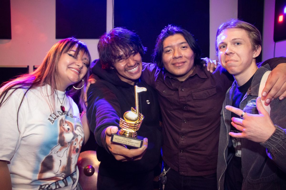 From left, Zombie Flower members Mary Grace, Angel Siberian, Boba Fierro Ryan Watson celebrate after securing first place at the Punk Rock at CSUN's Battle of the Bands at Pop Studios in Northridge, Calif., on Saturday, Feb. 22, 2025.