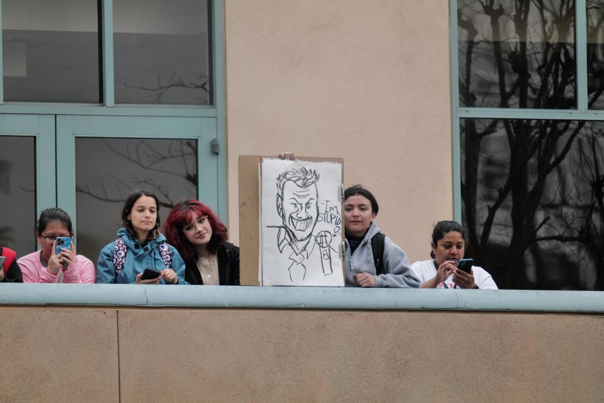 Students stand upstairs of the Southwest Addition of the USU in Northridge, Calif., watching from afar Charlie Kirk's visit to campus in Northridge, Calif., on Thursday, March 6, 2025.