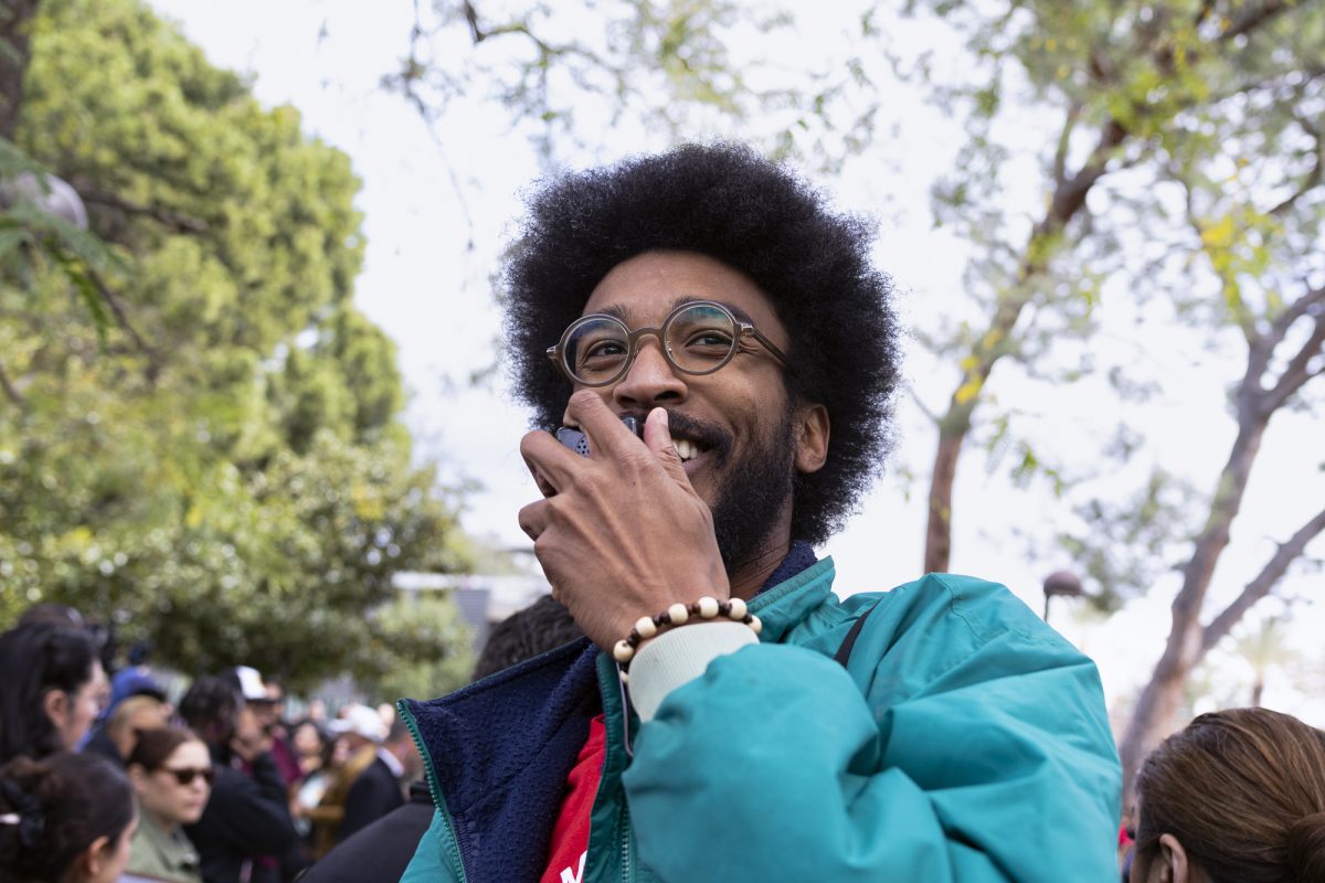 Speaker for "Party for Socialism and Liberation" speaks into a microphone in the crowd during the Charlie Kirk "The American Comeback Tour" on campus in Northridge, Calif., on Thursday, March 6, 2025.