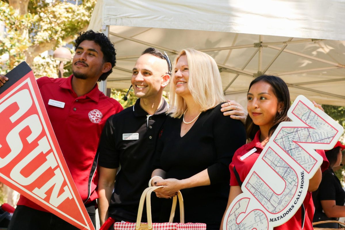 President Erika D. Beck taking photos with volunteers Ciro Martinez, Christopher Aston and Alexys Gutierrez at CSUN's annual President's Picnic at Bayramian Hall Lawn on Thursday, Sept. 4, 2025 in Northridge, Calif.