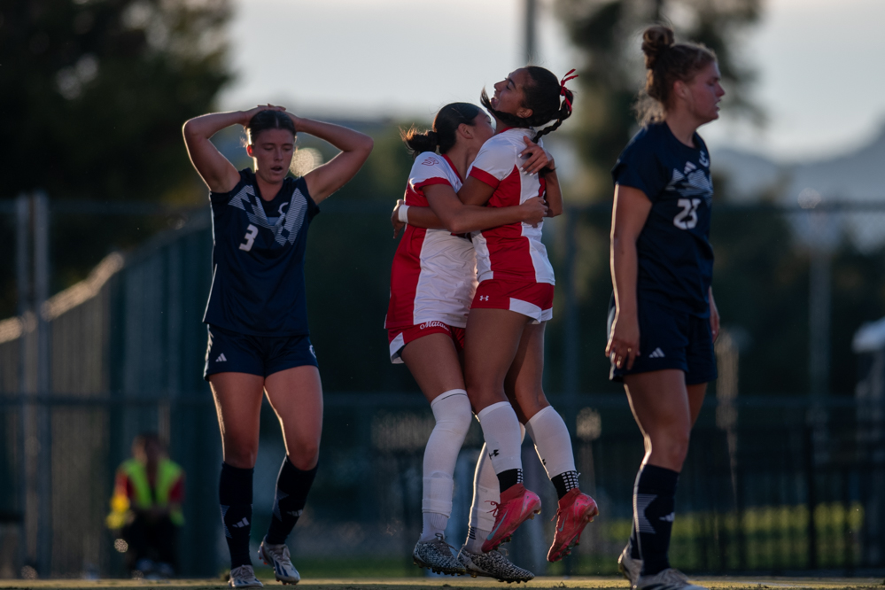 Yasmin Azar and Ariah Velazquez hug to celebrate Azar's goal during a game against UC Davis in Northridge, Calif., on Oct. 19, 2025. The CSUN Matadors won 1-0.